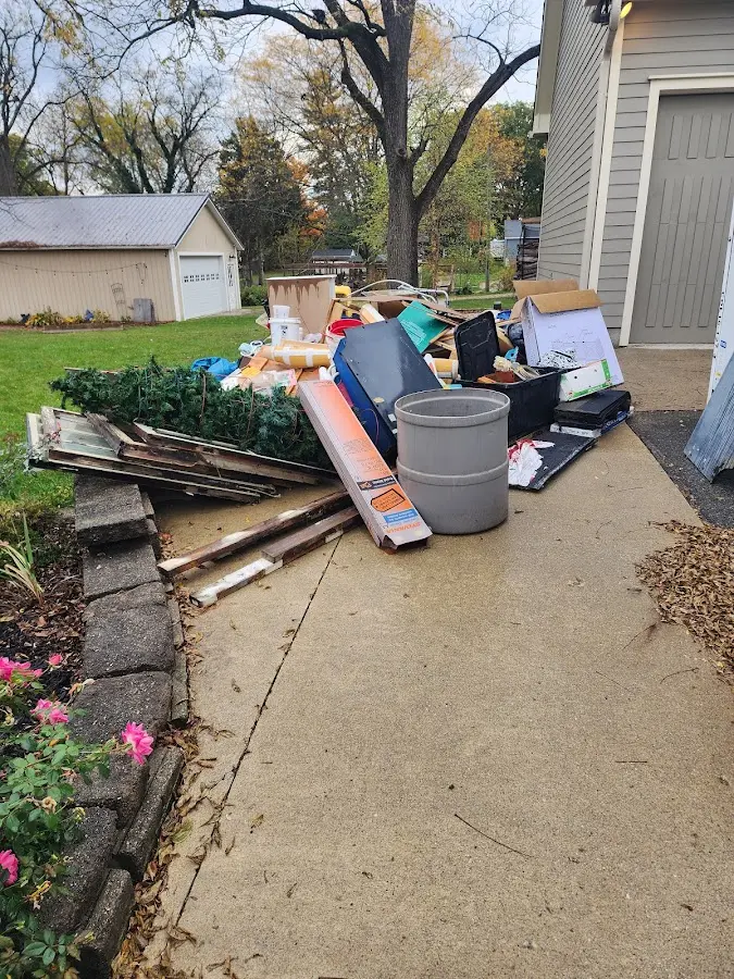 Dumpster being loaded with debris for Estate Cleanout Dumpster Rental in Mullica
